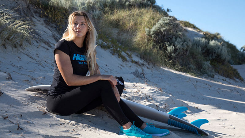 HOKA fan Lucy Campbell sits on the beach