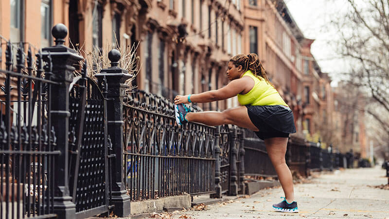 HOKA fan Latoya Snell stretches against a wall in New York