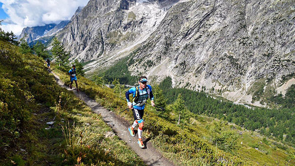 HOKA athlete Ludovic Pommeret runs through mountainous terrain