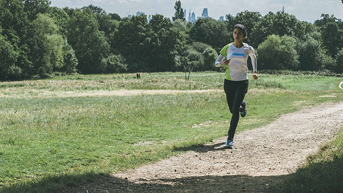 HOKA athlete Shirin Gerami runs through a park