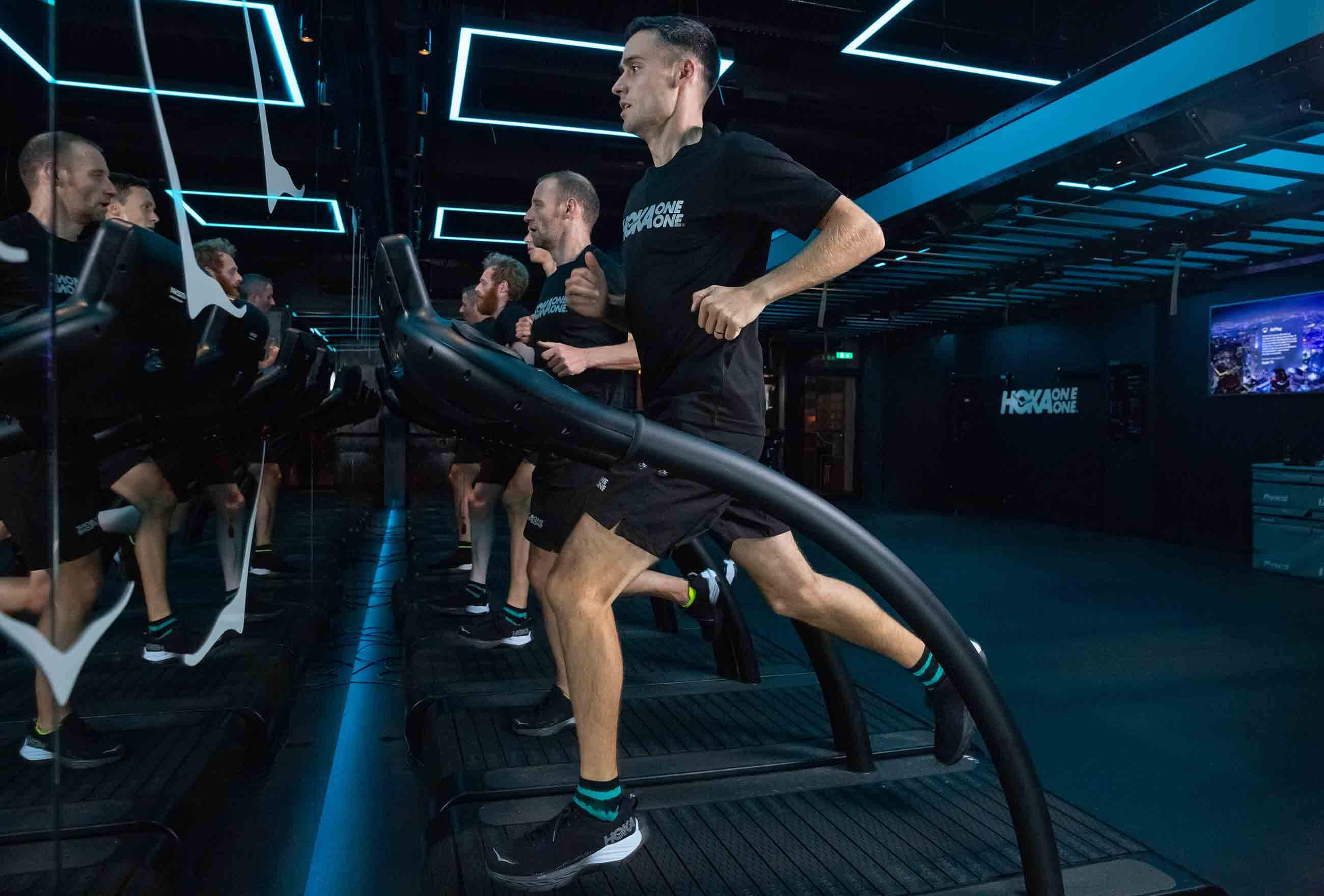 HOKA elite athlete Adam Hickey runs on the treadmill at the Fly at Night event in London