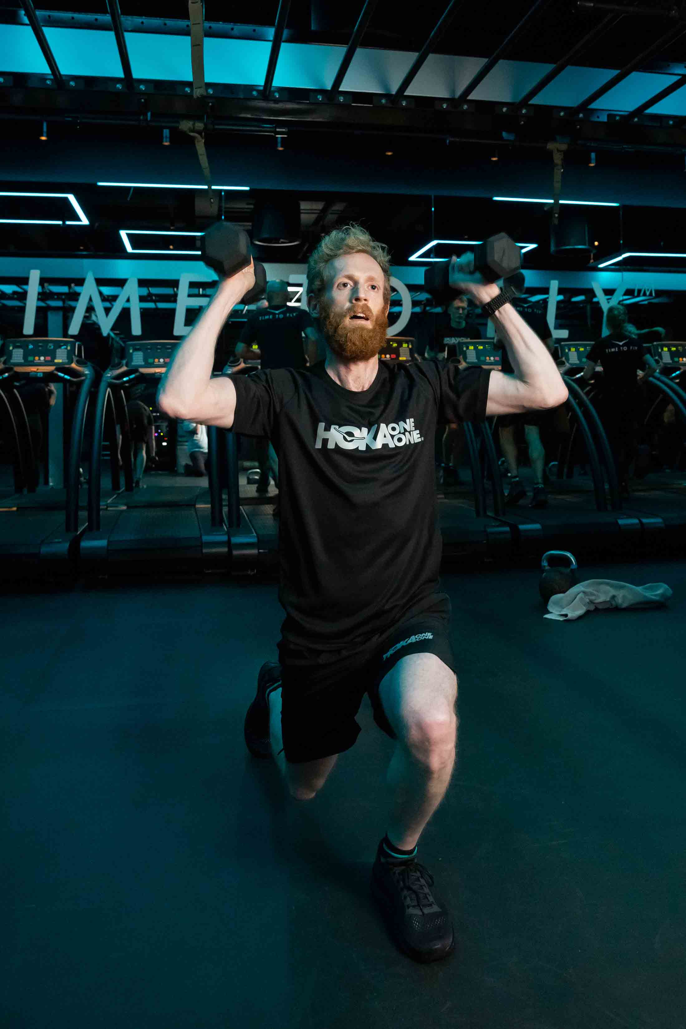 Participant lifts dumbbells at HOKA Fly at Night event in London