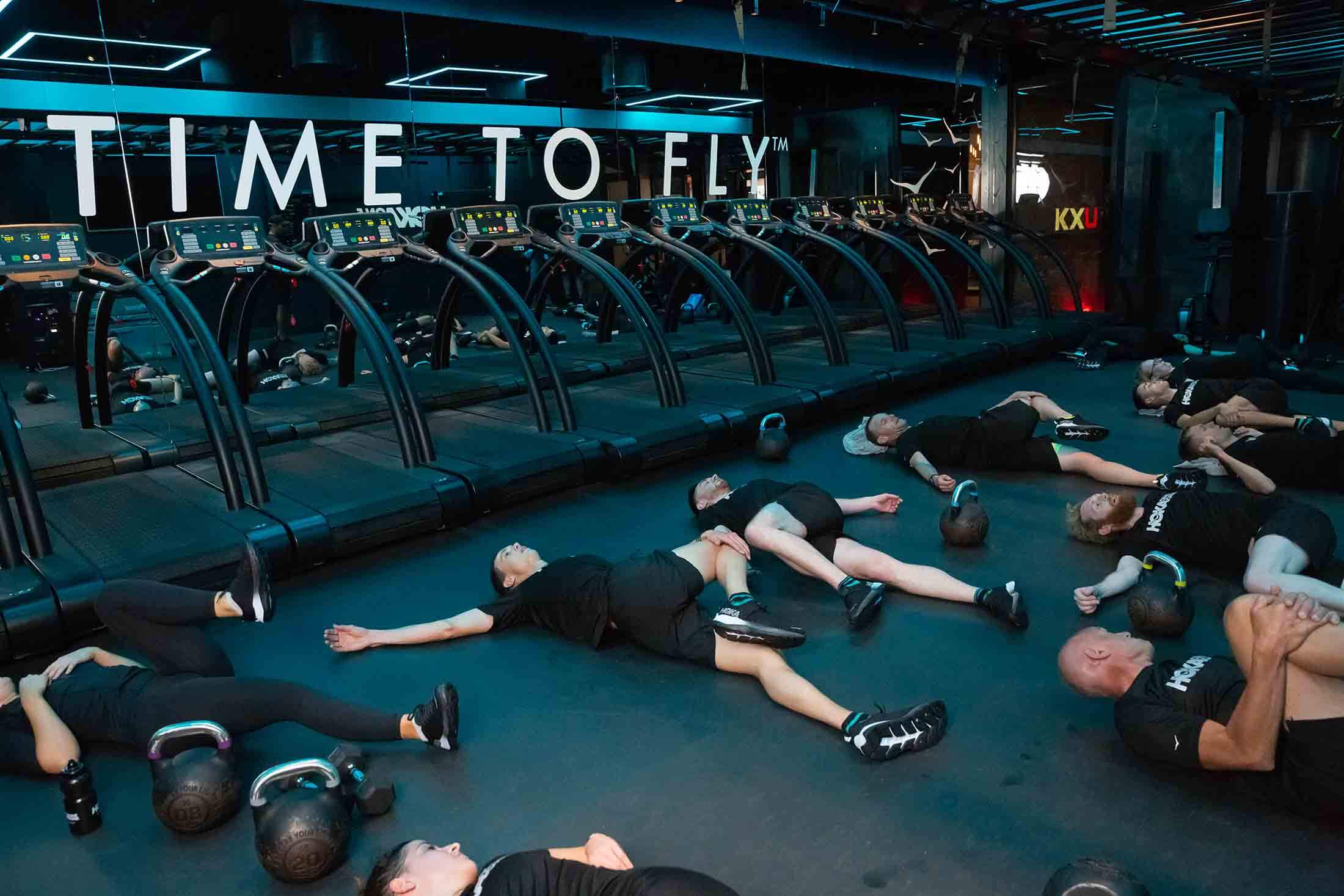 Participants stretch after the workout at HOKA Fly at Night event in London