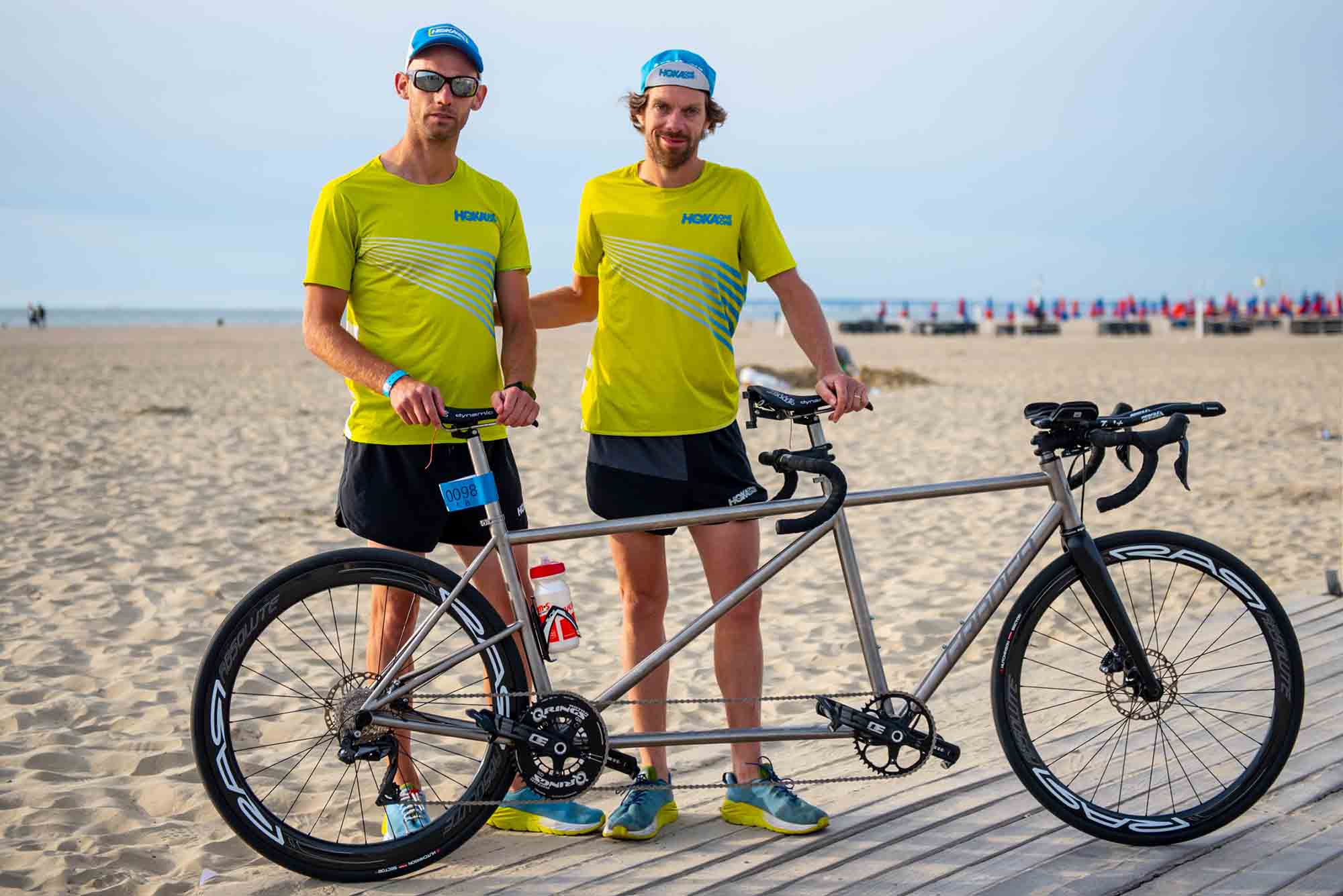 HOKA athletes Antoine Perel and Olivier Lyoen stand by their tandem bike
