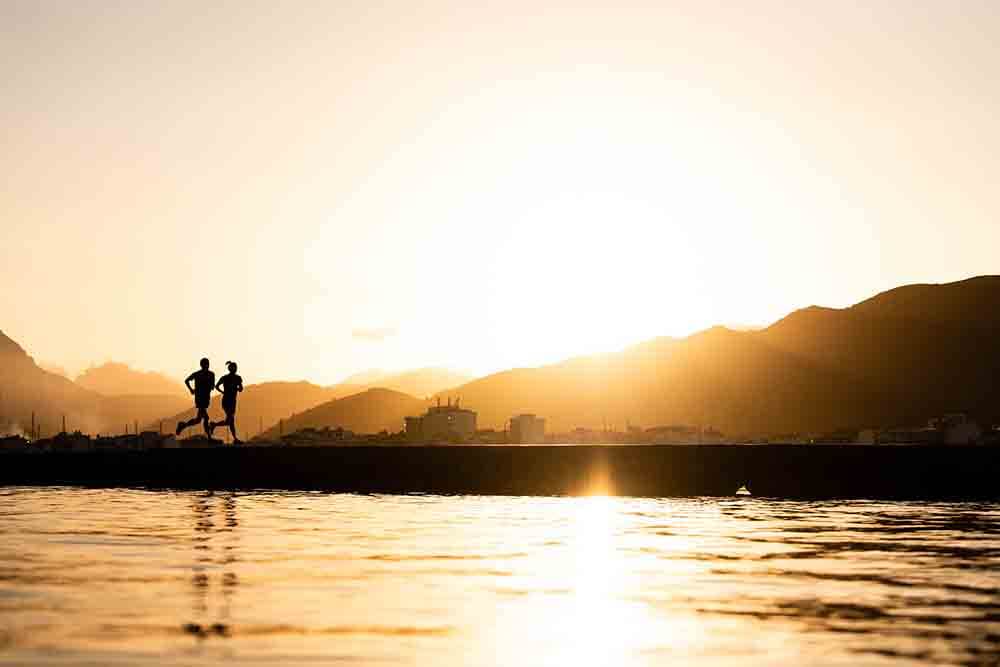 HOKA athletes running in the sunset