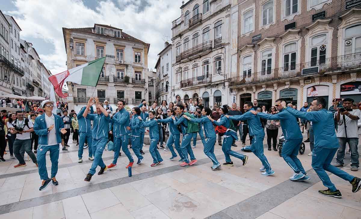 Team Italy do the conga in the town square