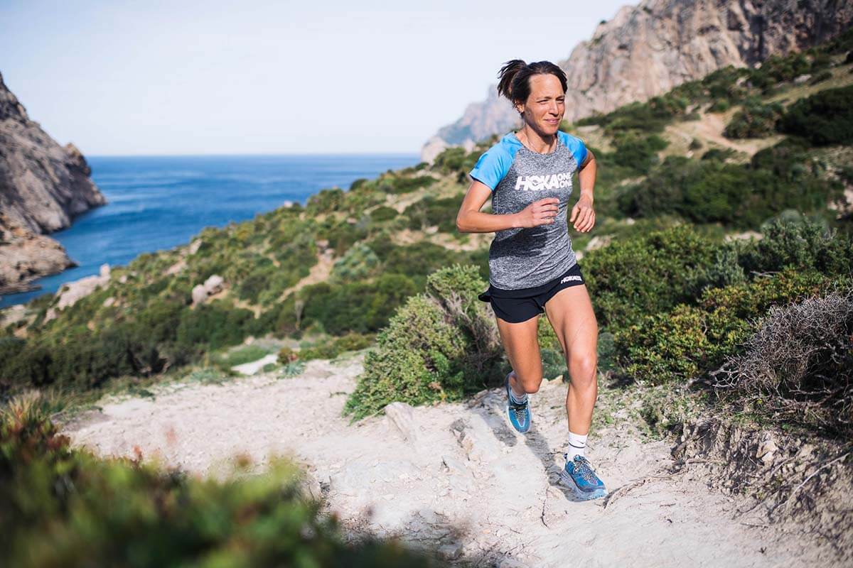 HOKA athlete Audrey Tanguy runs with the sea in the background