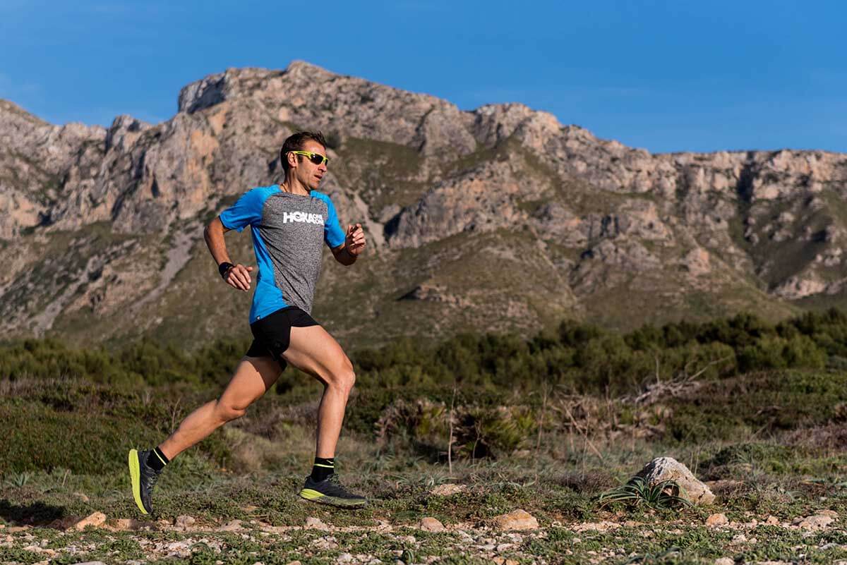 HOKA athlete Franco Colle runs with the mountain in the background