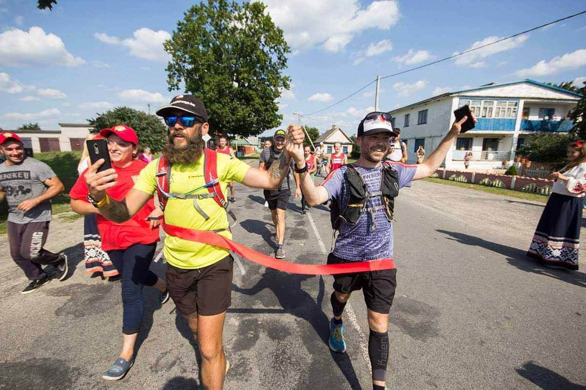 HOKA fans Jared and the Bearded Runner cross the finish line together