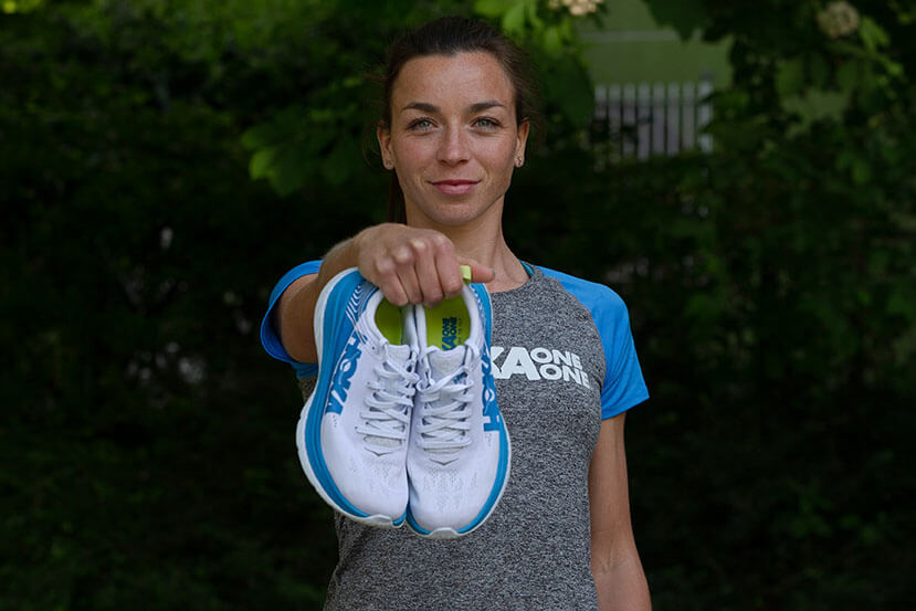HOKA athlete Manon Genet holds a pair of Carbon X to the camera
