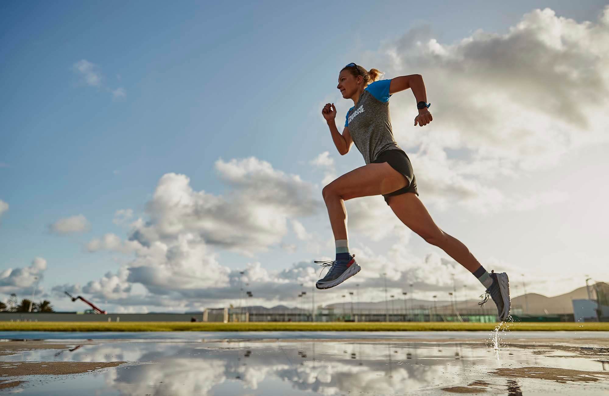 HOKA athlete Carolin Lehrieder runs across the wet ground