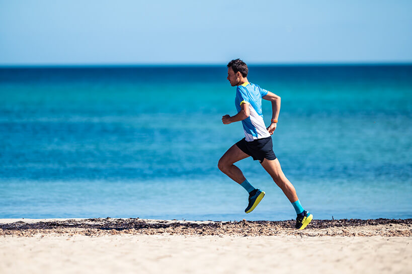 HOKA athlete Thibat Garrivier runs across the beach